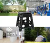 Collage of images showing a black folding stool in different settings: a garden, a workshop, a kitchen, and a campsite. Náhled obrázku produktu