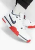 A close-up shot of a person wearing Nike Cross Trainer Low sneakers. Náhled obrázku produktu