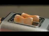 Two slices of bread are toasting in a silver toaster. Produktbild-Vorschau