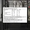 A close-up of a nutrition label on a dark background, with gym equipment visible in the background. Produktbild-Vorschau