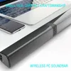 A soundbar is placed on a desk next to a laptop and a smartphone. Produktbild-Vorschau