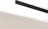 A black track light rail mounted on a white ceiling above a light beige wall. Anteprima dell’immagine prodotto