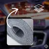A close-up of a rolled-up gray fabric with a diagram showing its layered structure. Produktbild-Vorschau