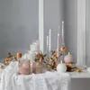 A collection of LED candles and decorative elements arranged on a white lace tablecloth. Produktbild-Vorschau