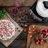 A kitchen scene with a food mixer and ingredients for a dessert. Anteprima dell’immagine prodotto
