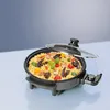 A close-up shot of an electric pan filled with paella, placed on a light blue surface with a blue gradient background. Produktbild-Vorschau