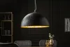 A modern dining room with a black pendant light hanging over a table. Produktbild-Vorschau