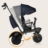 A Lionelo Kori tricycle is shown against a plain background, with an inset detail of the rear wheel and an arrow pointing to the front wheel mechanism. Podgląd zdjęcia produktu