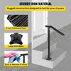 A black metal handrail is installed on a set of outdoor stairs leading to a white door. The image includes inset panels highlighting product features like thickened tubing, a solid base, and ease of cleaning. Podgląd zdjęcia produktu