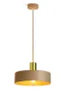A modern pendant light with a beige shade and gold accents, suspended from a cord. Produktbild-Vorschau