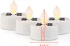 Four white solar-powered LED tea lights with flame-shaped tops are arranged in a group on a white background. Dimensions are indicated with orange lines and text. Anteprima dell’immagine prodotto