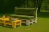 A pallet sofa and coffee table set with cushions on a grassy lawn, with trees in the background. Produktbild-Vorschau