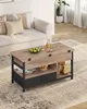 A coffee table with storage is placed in a living room setting next to a sofa. Voir les images du produit