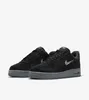 A pair of black Nike Air Force 1 sneakers with a gray sole, shown against a white background. Anteprima dell’immagine prodotto