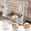 A white bunk bed with a desk and stairs, shown in a room setting with some decorative elements. Produktbild-Vorschau