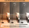 Three floor lamps are shown in different lighting conditions, demonstrating color temperature and brightness adjustments. The lamps are placed in a living room setting with chairs and cushions. Produktbild-Vorschau