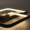 A close-up view of a modern, geometric LED ceiling light fixture. Produktbild-Vorschau