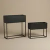 Two black metal planters on stands against a plain background. Produktbild-Vorschau