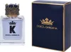 A bottle of Dolce & Gabbana K Eau de Toilette and its matching dark blue box with gold accents are displayed side-by-side against a white background. Produktbild-Vorschau