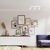 A modern living room with a white sideboard, a gallery wall, and a blue sofa. Podgląd zdjęcia produktu