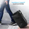 A person is pulling a black speaker on wheels down a sidewalk. Produktbild-Vorschau