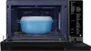 Interior view of an open microwave with a blue and white steaming container inside, placed on the turntable. Voir les images du produit