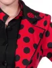 Close-up of a woman wearing a red and black polka dot jacket with a ladybug brooch on the collar. Produktbild-Vorschau