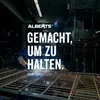 A welder is working on a metal fence in a workshop, with text overlays. Produktbild-Vorschau