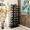 A modern wine rack filled with wine bottles, placed in a room with a brick wall and a painting, next to a large decorative plant. Podgląd zdjęcia produktu