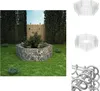 A hexagonal gabion raised garden bed filled with plants sits on a green lawn, with a wooden fence and tall hedges in the background. Podgląd zdjęcia produktu