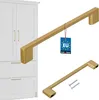 Two gold cabinet handles are shown, one large and one smaller, against a white background. A white cabinet with gold handles is partially visible on the left. A tag with EU and "kotarbau" logo is attached to the larger handle. Produktbild-Vorschau