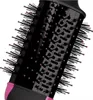 A close-up view of the bristles and barrel of a black and pink hair dryer brush. Podgląd zdjęcia produktu