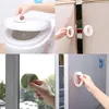 Collage of four images showing self-adhesive handles being used on a toilet seat, cabinet doors, a window, and a refrigerator. Produktbild-Vorschau
