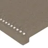 A close-up view of a taupe fabric headboard with decorative studs. Produktbild-Vorschau
