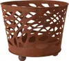 A rusty metal basket with a decorative cutout pattern, resting on three small ball feet. Náhled obrázku produktu