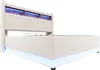 A beige upholstered bed frame with built-in LED lighting in the headboard and under the base, shown from a side angle against a white background. Náhled obrázku produktu