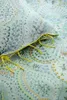 A close-up of a light blue duvet cover with a floral pattern and yellow ties. Produktbild-Vorschau