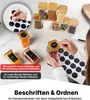 A flat lay of spice jars with labels and a hand applying a label to a jar. Anteprima dell’immagine prodotto