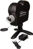A black projector with a tripod, power adapter, and lens cap. Náhled obrázku produktu
