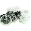 A string of clear glass light bulbs with black cords and sockets, arranged in a cluster against a white background. Anteprima dell’immagine prodotto