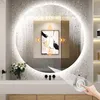 A modern bathroom vanity with a large illuminated mirror, featuring a piece of abstract art displayed within the mirror's reflection. The mirror has a touch-sensitive control panel and is surrounded by a textured wall. Voir les images du produit
