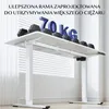 A white adjustable desk with weights on top and blue letters spelling "70 KG". Podgląd zdjęcia produktu