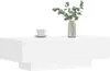 A white coffee table with a vase of greenery and a cup of coffee on top, set against a white background. Náhled obrázku produktu