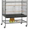 A bird cage on a stand with two bags of birdseed and two brushes on the lower shelf. Produktbild-Vorschau