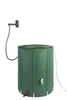 A green collapsible rain barrel with a hose and shower head attachment, shown against a white background. Produktbild-Vorschau