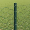 A close-up view of a green wire fence post with hexagonal mesh fencing attached, set against a blurred green grassy background. Náhled obrázku produktu