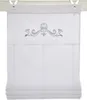 A white Roman blind with a silver crown and floral embroidery at the top, hanging from a curtain rod. Produktbild-Vorschau