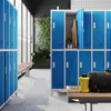 A modern locker room with blue metal lockers and wooden benches. Anteprima dell’immagine prodotto