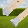 Two wooden beams with metal brackets attached, set against a blurred background of green grass and a blue sky. Anteprima dell’immagine prodotto
