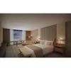 A hotel room with a large window overlooking a cloudy sky. Produktbild-Vorschau